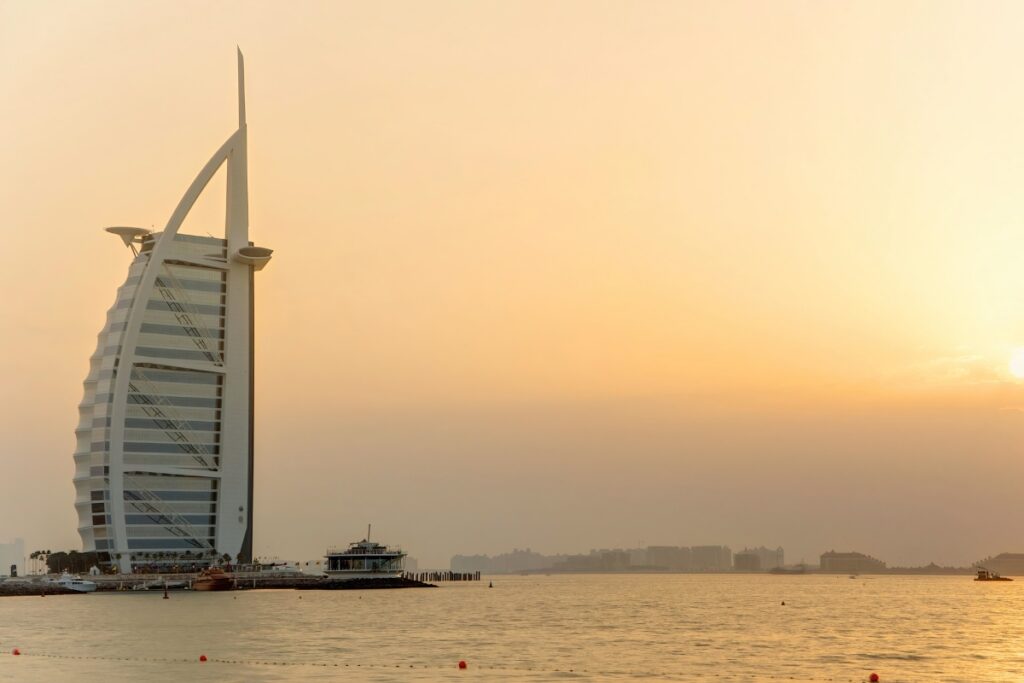 People enjoying a sunset swim at Jumeirah Night and Evening Beach, Dubai.