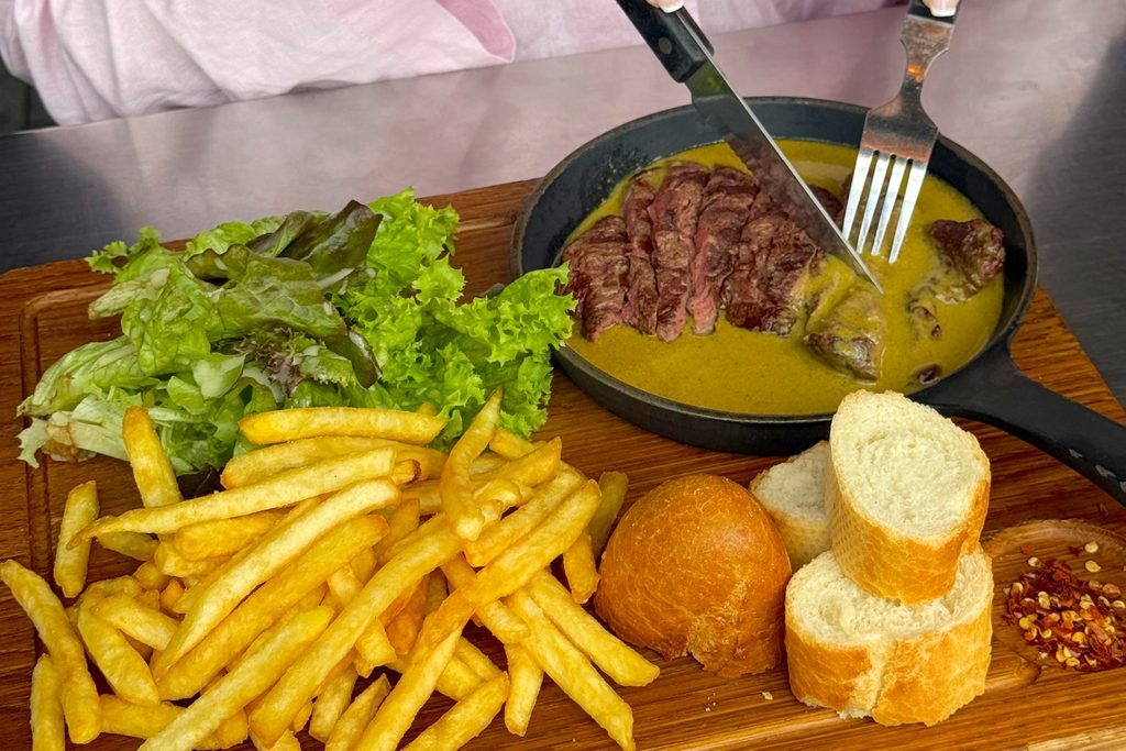 Steak with butter sauce and fries at Swiss Butter Dubai