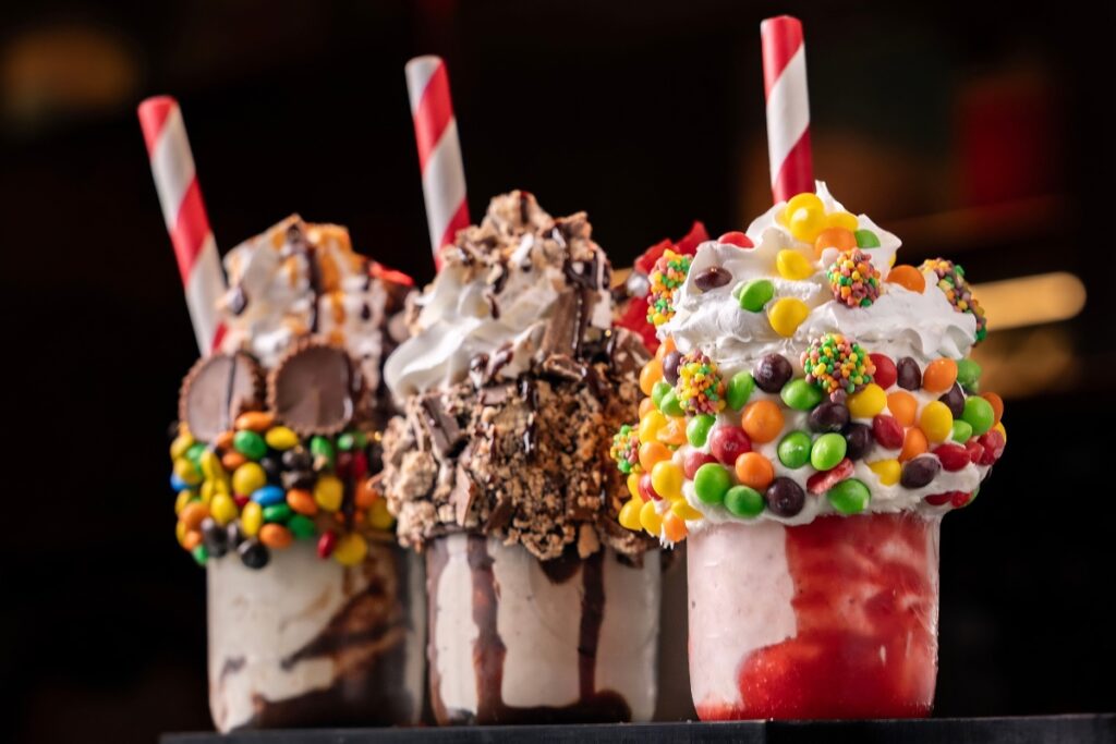 Black Tap CrazyShake topped with cakes and cookies, a unique frozen dessert in Dubai